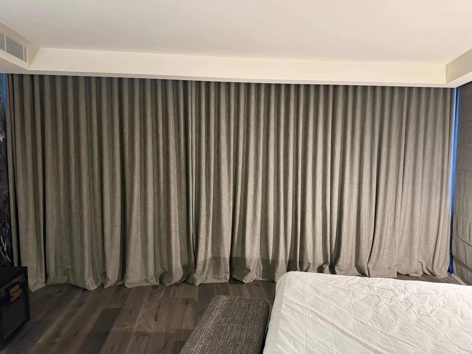 Grey blockout curtains in a modern living room for complete light control