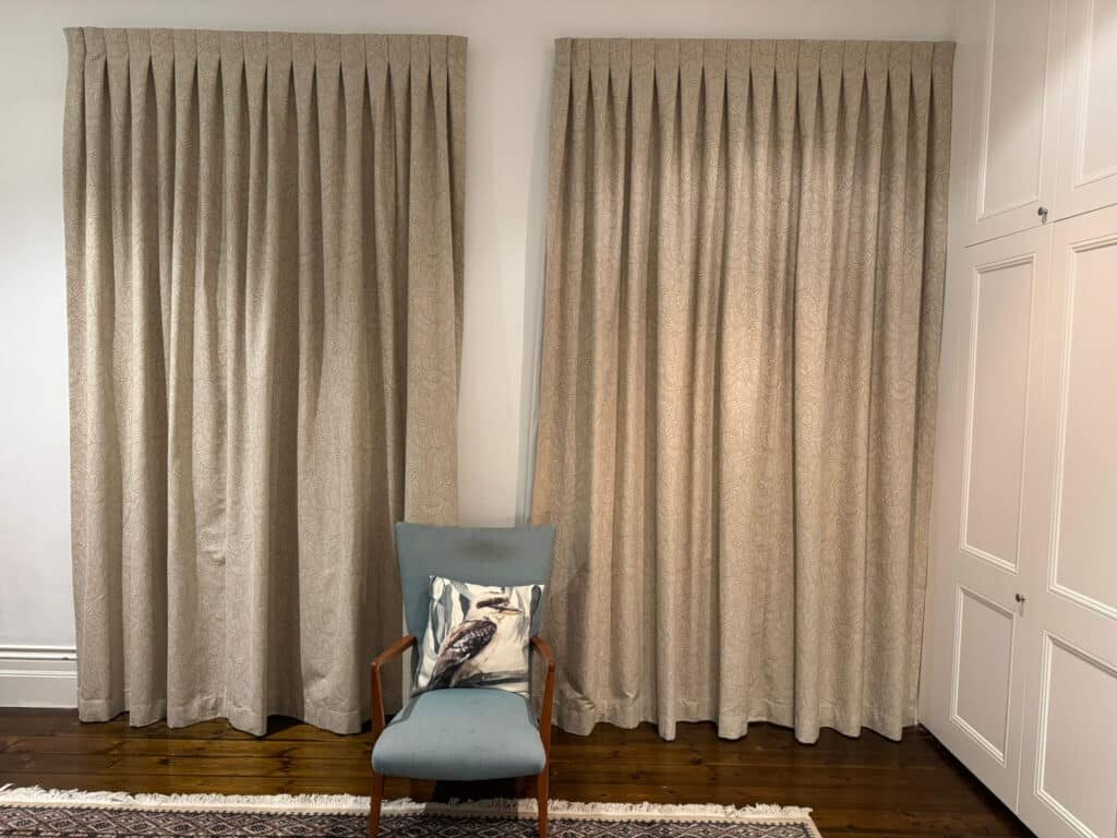 Blockout curtains in a cozy bedroom, reducing outside light for better sleep.