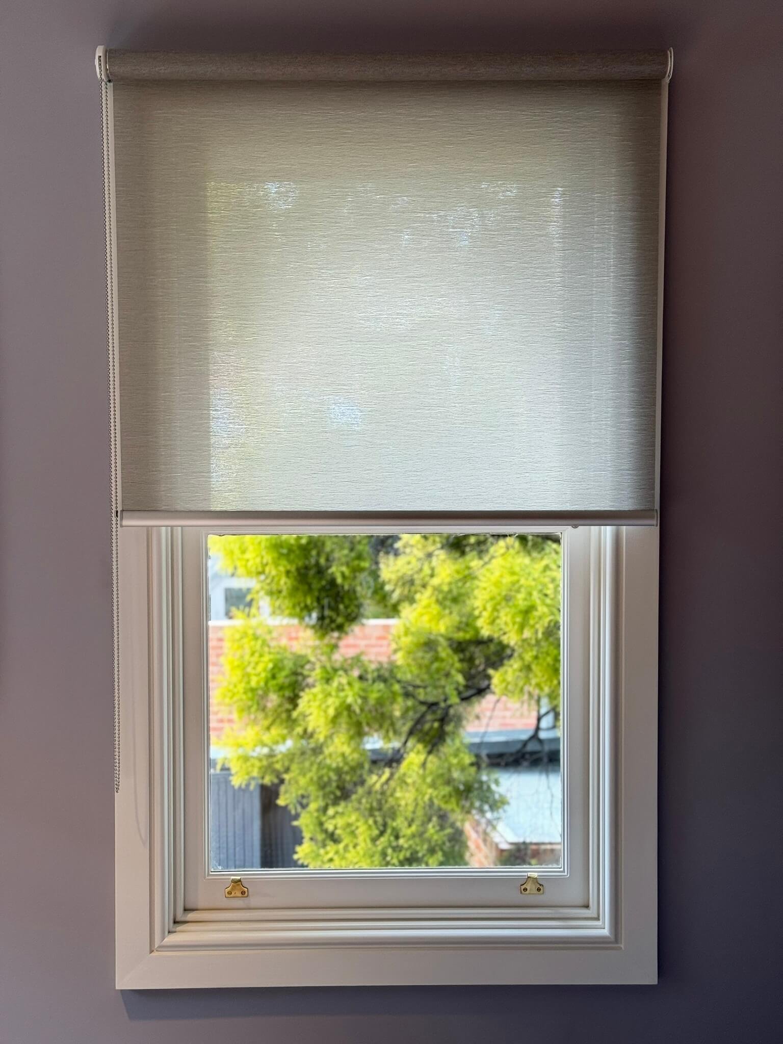 legant light-filtering roller blinds in a living room, allowing soft natural light while maintaining privacy