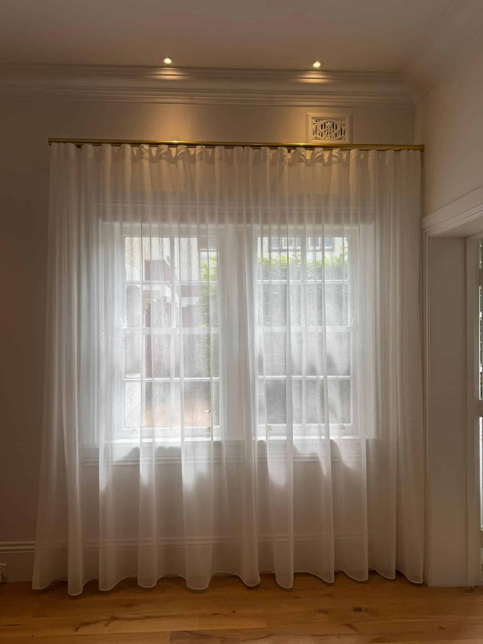 Sheer S-Fold curtains creating a soft, airy ambiance in a sunlit bedroom.