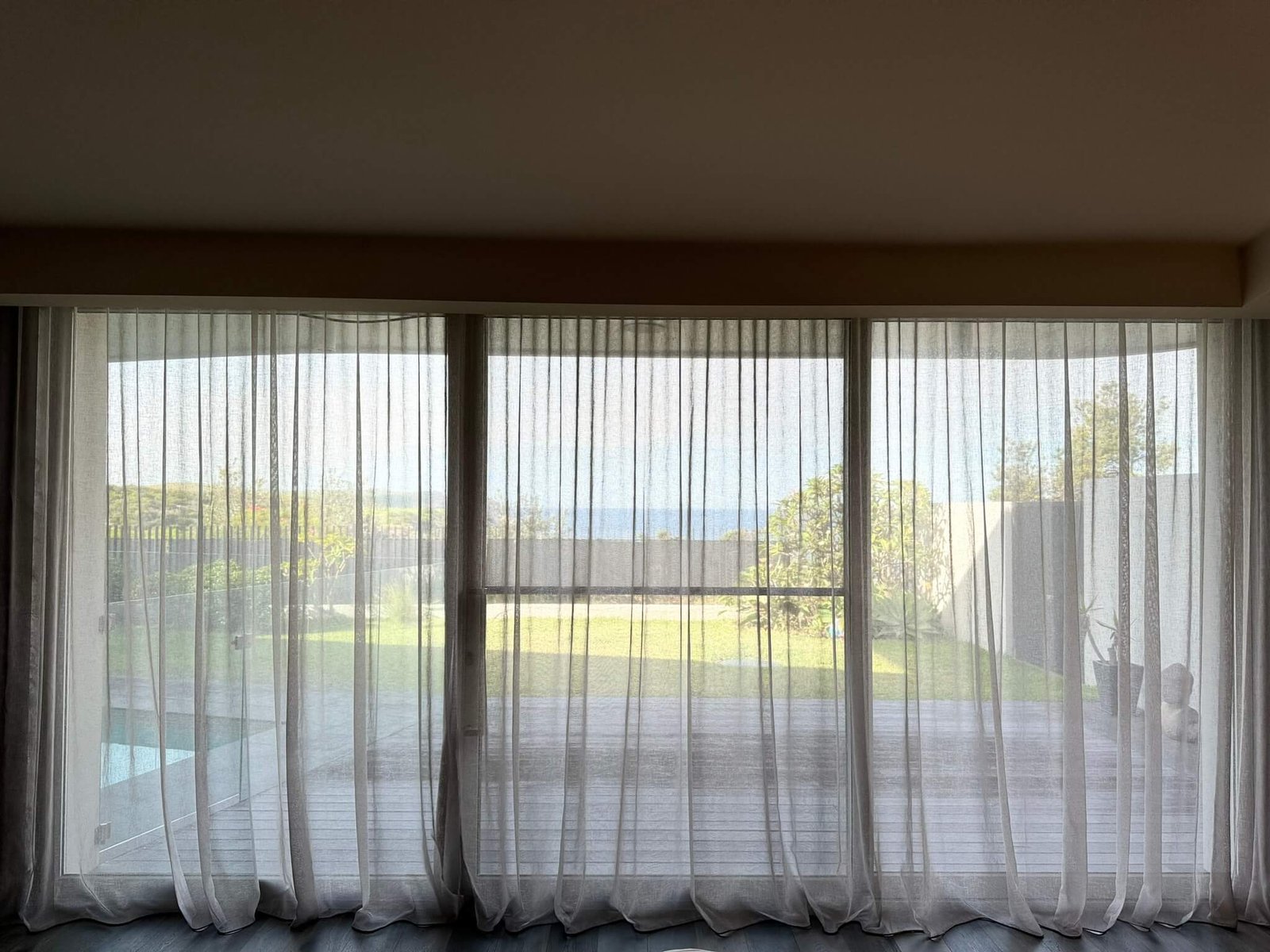 Remote-controlled motorized S-Fold curtains in a modern smart home setup.