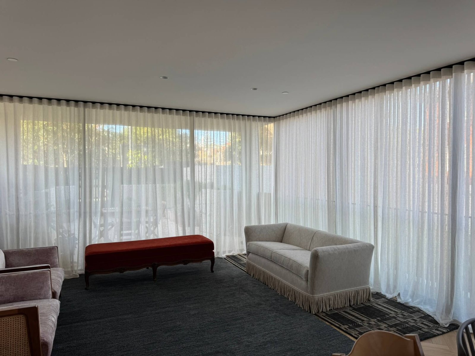 Elegant white S-Fold curtains installed in a modern living room for a seamless and stylish look.